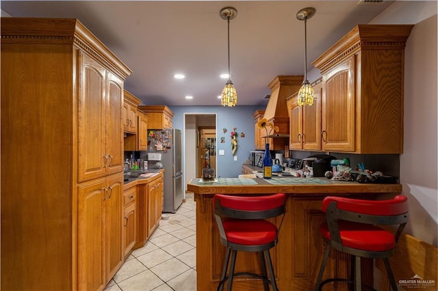 kitchen featuring light tile patterned floors, recessed lighting, a peninsula, a breakfast bar, and pendant lighting