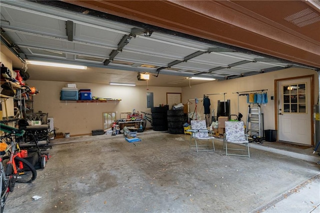 garage with electric panel and a garage door opener