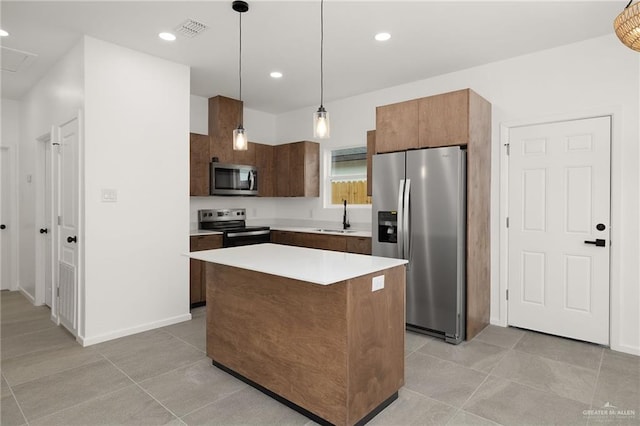 kitchen with visible vents, appliances with stainless steel finishes, a sink, light tile patterned floors, and light countertops