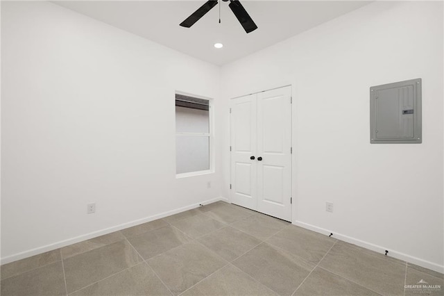 empty room featuring baseboards, electric panel, a ceiling fan, and recessed lighting