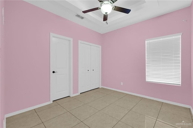3120 La Puerta Ave, Edinburg, TX 78541 - unfurnished bedroom featuring a raised ceiling, ceiling fan, light tile patterned flooring, and a closet