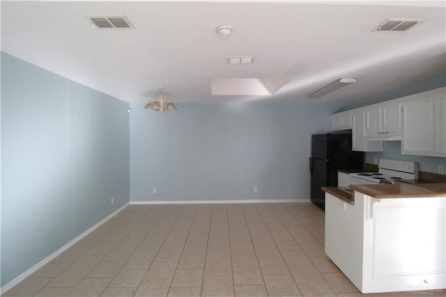 kitchen featuring white cabinets, black refrigerator, electric range, and light tile patterned floors