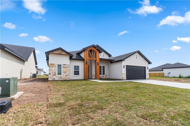 519 Oriole Dr, Los Fresnos, TX 78566 - modern inspired farmhouse featuring central AC unit, driveway, a front lawn, a garage, and stone siding