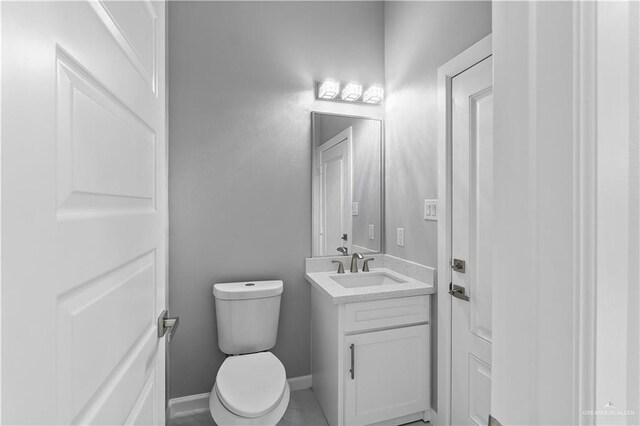 519 Oriole Dr, Los Fresnos, TX 78566 - half bathroom featuring vanity, toilet, and baseboards