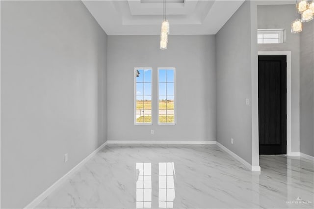 519 Oriole Dr, Los Fresnos, TX 78566 - empty room featuring a tray ceiling, baseboards, and marble finish floor