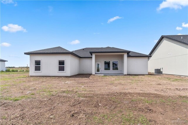 519 Oriole Dr, Los Fresnos, TX 78566 - back of house featuring stucco siding and central AC unit