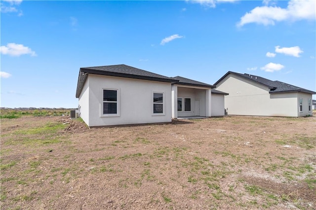 519 Oriole Dr, Los Fresnos, TX 78566 - back of house with stucco siding and cooling unit