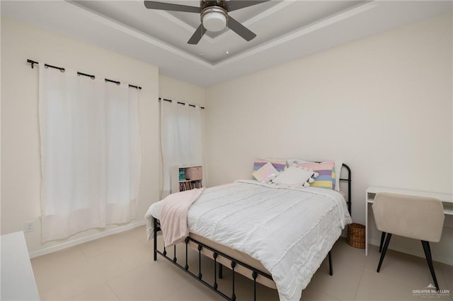 bedroom with a tray ceiling and ceiling fan