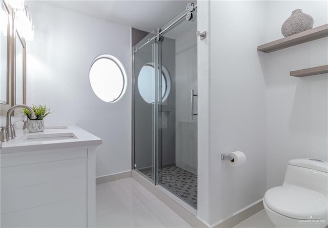 bathroom with tile patterned flooring, vanity, toilet, and a shower with shower door