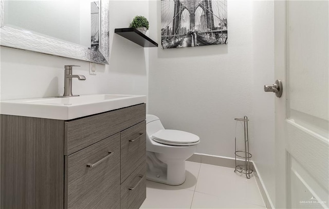 bathroom with tile patterned flooring, vanity, and toilet