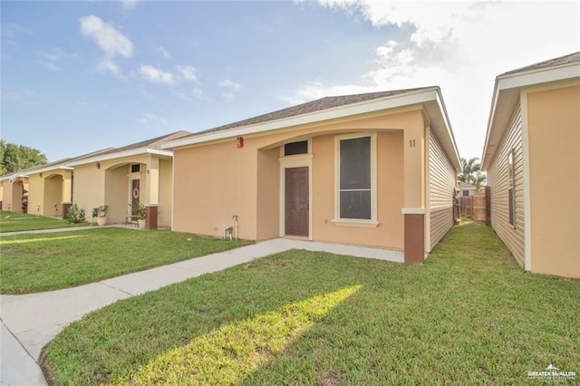 ranch-style home with a front lawn