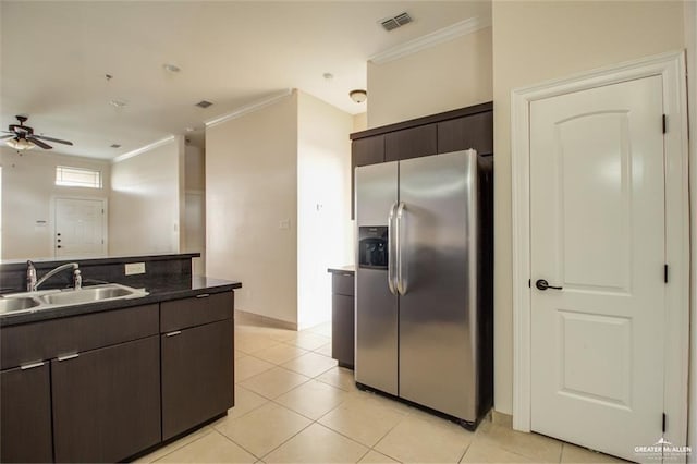 kitchen with ornamental molding, sink, dark brown cabinetry, and stainless steel fridge with ice dispenser