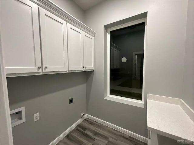 clothes washing area with baseboards, hookup for a washing machine, dark wood-type flooring, hookup for an electric dryer, and cabinet space