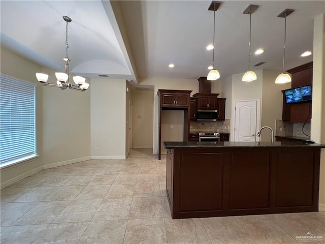 kitchen featuring appliances with stainless steel finishes, decorative light fixtures, dark brown cabinets, and a notable chandelier