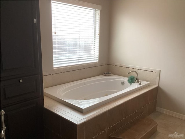 bathroom with a healthy amount of sunlight, tiled bath, and tile patterned flooring