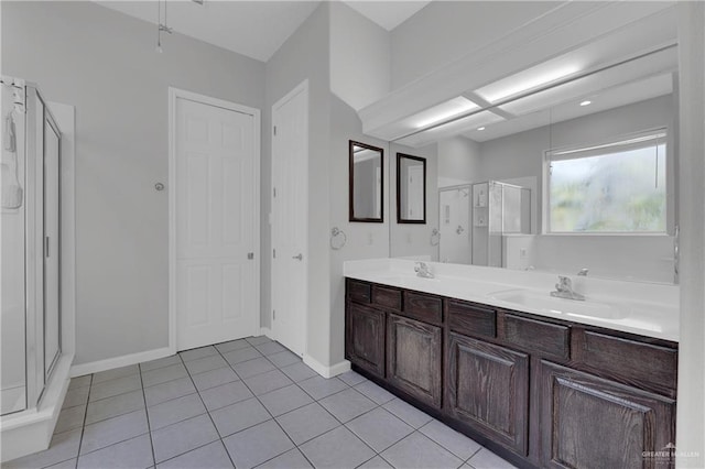 bathroom featuring tile patterned flooring, vanity, and an enclosed shower