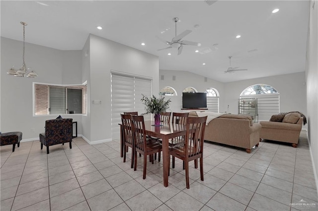 dining room with light tile patterned floors, ceiling fan with notable chandelier, and vaulted ceiling