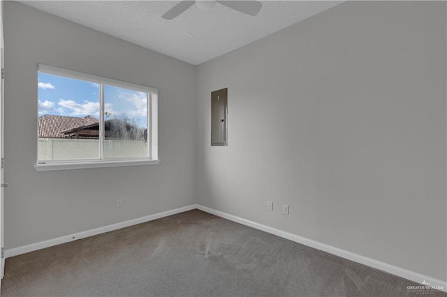 carpeted spare room featuring ceiling fan and electric panel