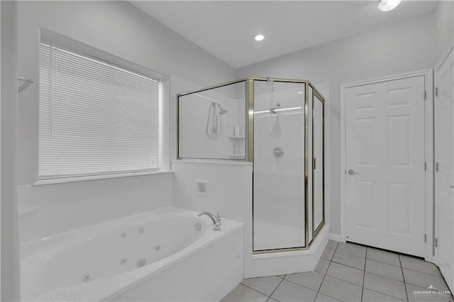 bathroom with tile patterned flooring and independent shower and bath