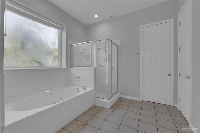 bathroom with tile patterned flooring and separate shower and tub