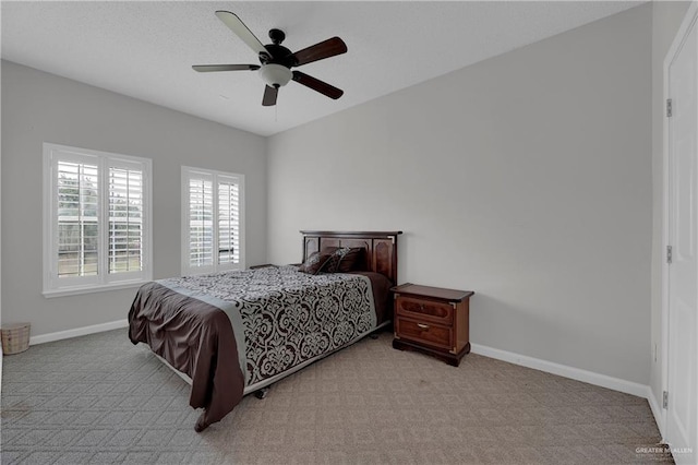 bedroom with ceiling fan and light colored carpet