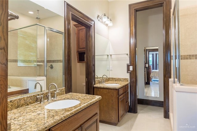 bathroom featuring vanity, tile patterned floors, and a shower with door