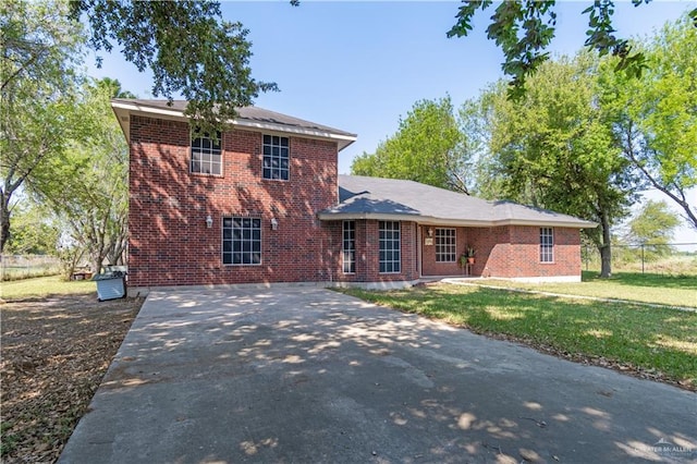 1309 El Camino Dr, Weslaco, TX 78599 - view of front facade featuring brick siding and driveway