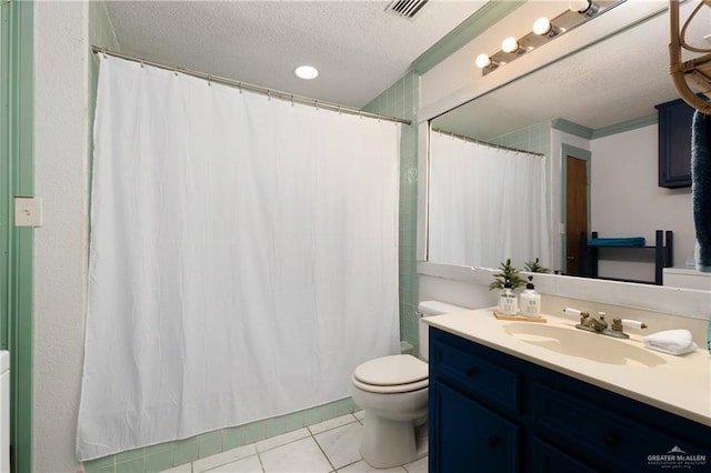 130 E Gardenia St, South Padre Island, TX 78597 - bathroom with a textured ceiling, vanity, visible vents, toilet, and tile patterned floors