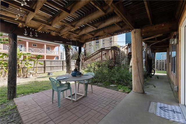 130 E Gardenia St, South Padre Island, TX 78597 - view of patio / terrace with fence, outdoor dining area, and stairway