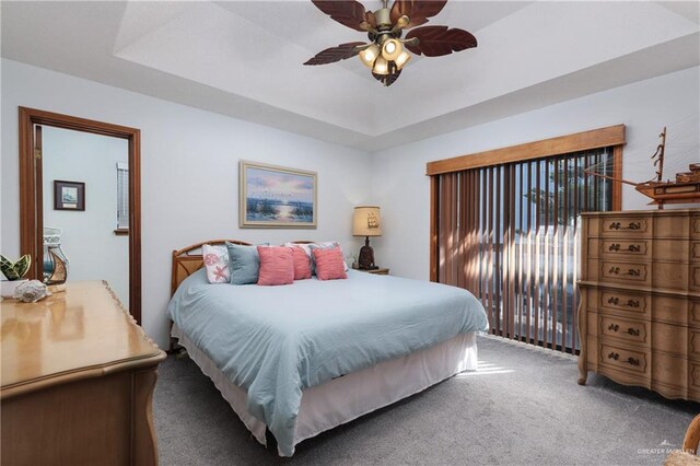 130 E Gardenia St, South Padre Island, TX 78597 - carpeted bedroom with a raised ceiling, access to exterior, and ceiling fan