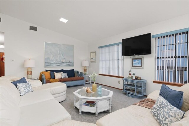 130 E Gardenia St, South Padre Island, TX 78597 - carpeted living area with visible vents, baseboards, and lofted ceiling