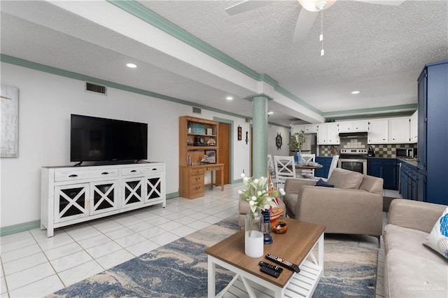 130 E Gardenia St, South Padre Island, TX 78597 - living room with ornate columns, a textured ceiling, a ceiling fan, visible vents, and baseboards