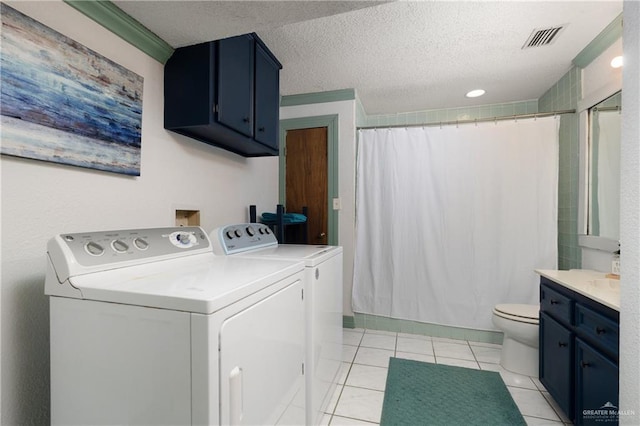 130 E Gardenia St, South Padre Island, TX 78597 - washroom featuring visible vents, washer and dryer, laundry area, a textured ceiling, and light tile patterned flooring