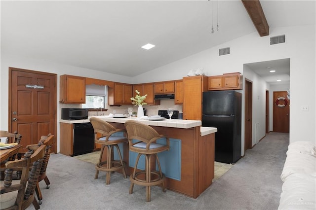 130 E Gardenia St, South Padre Island, TX 78597 - kitchen featuring visible vents, lofted ceiling with beams, under cabinet range hood, black appliances, and light colored carpet