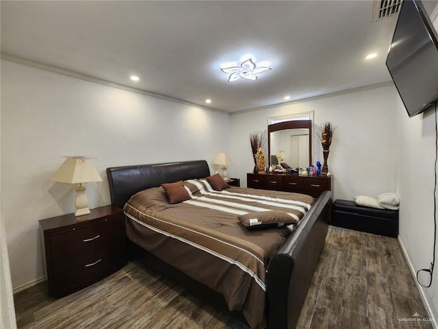 bedroom featuring dark hardwood / wood-style flooring and crown molding