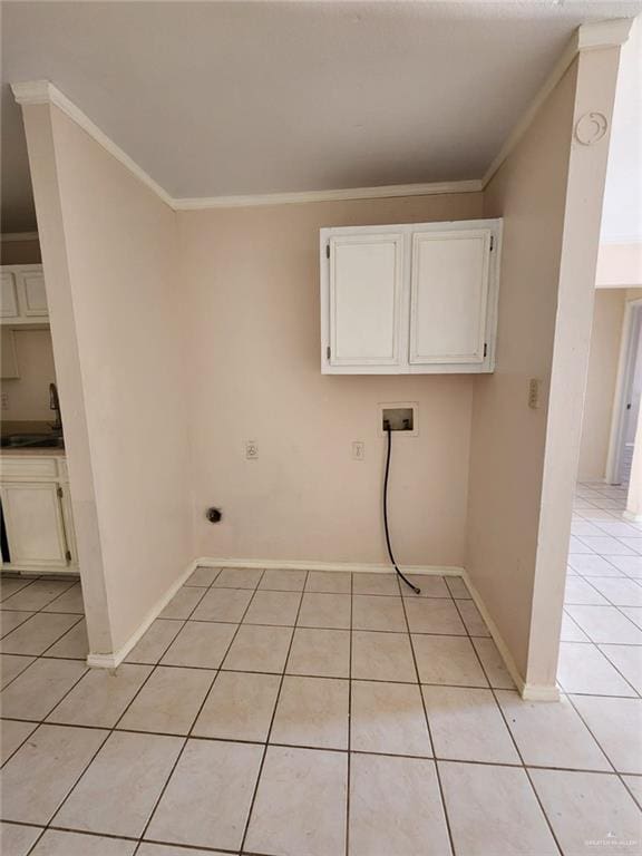 laundry room with sink, cabinets, crown molding, hookup for a washing machine, and light tile patterned floors