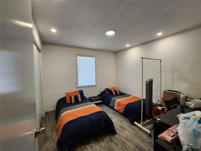 bedroom featuring dark hardwood / wood-style floors and ornamental molding