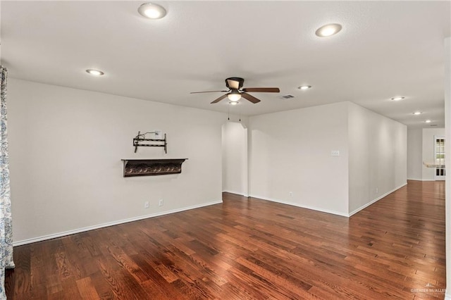 spare room featuring dark hardwood / wood-style flooring and ceiling fan