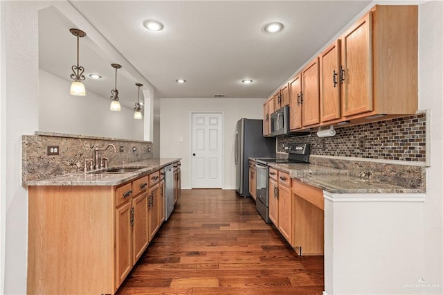 kitchen featuring sink, dark hardwood / wood-style floors, appliances with stainless steel finishes, decorative light fixtures, and kitchen peninsula