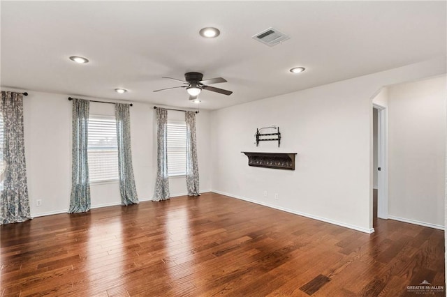 unfurnished room with ceiling fan and dark hardwood / wood-style flooring