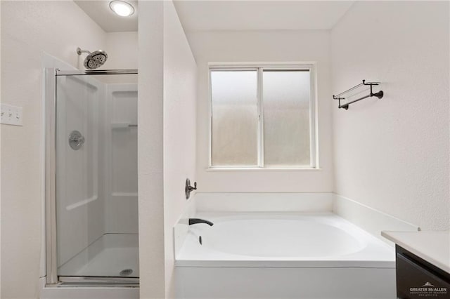 bathroom with plenty of natural light, separate shower and tub, and vanity