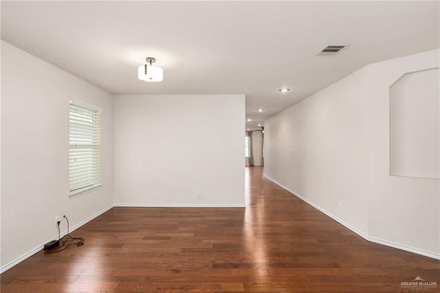 empty room with dark wood-type flooring