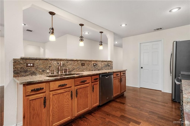 125 Katie Ct, Boerne, TX 78006 - kitchen featuring stainless steel appliances, dark wood-style flooring, brown cabinetry, stone countertops, and pendant lighting