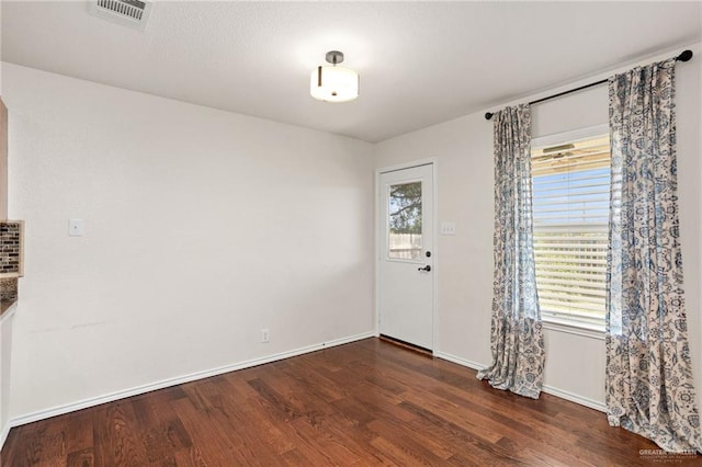 interior space with dark hardwood / wood-style floors and plenty of natural light