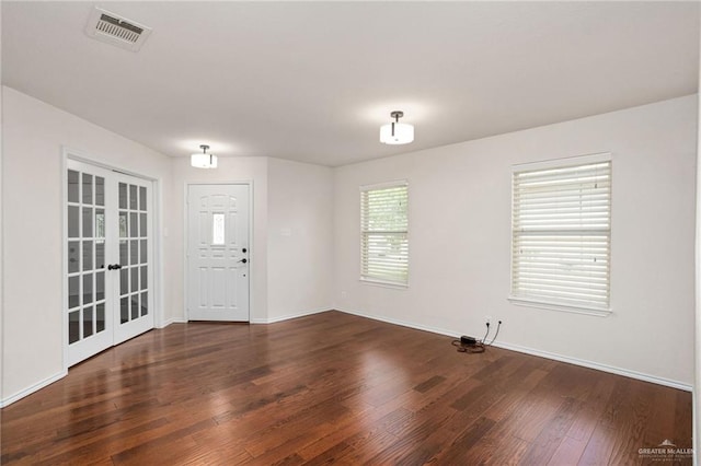 spare room with french doors and dark hardwood / wood-style flooring