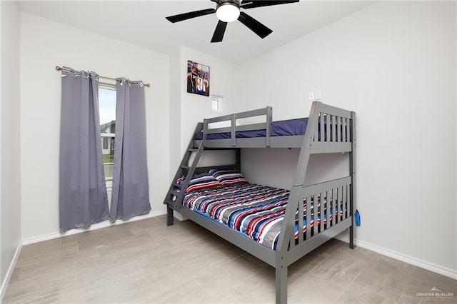bedroom with baseboards and ceiling fan