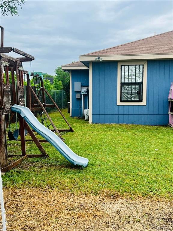 view of jungle gym featuring a lawn