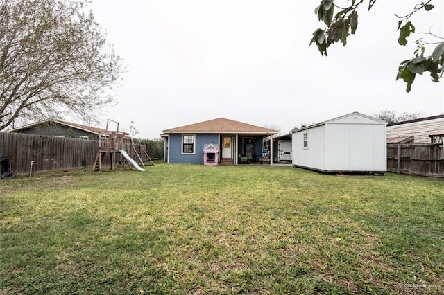 view of yard featuring a playground and a storage unit