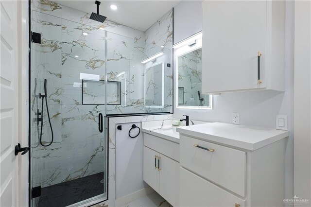 bathroom with a marble finish shower, recessed lighting, marble finish floor, and vanity