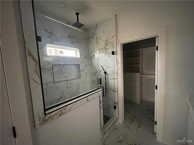 bathroom featuring marble finish floor and a marble finish shower